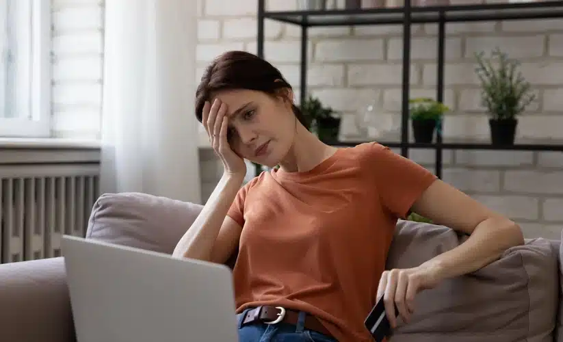 sad woman looking at laptop
